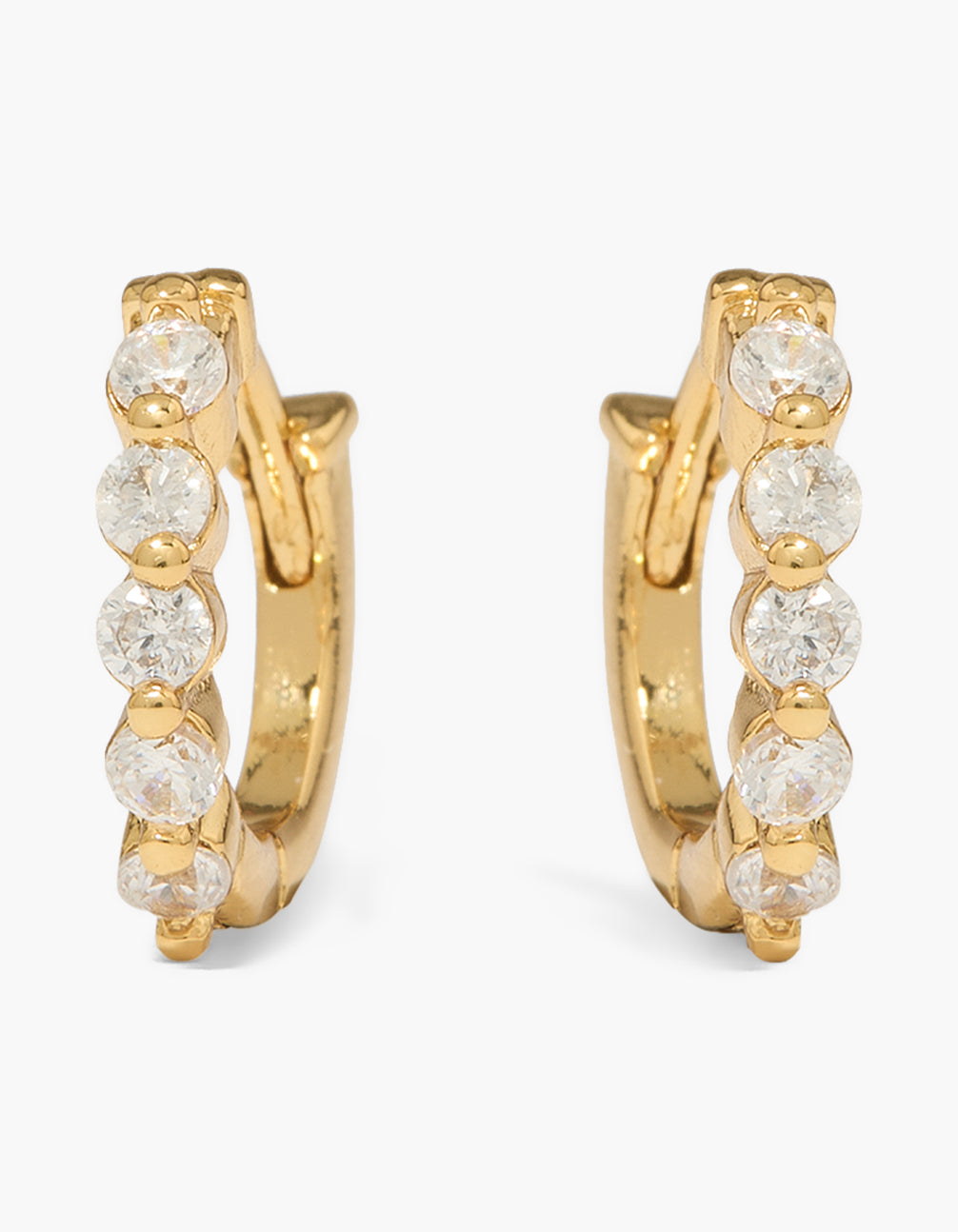 Beautifully crafted mini huggie earrings in gold plated with cubic zirconia and huggie closure close up view