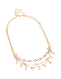 Showcasing a gold pink diamantes triple layered necklace with charm detailing in a statement style front view - link has visual effect only