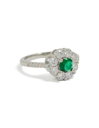 Showcasing a dainty ring with green cubic zirconia center stone and clear floral halo design in silver front view - link has visual effect only