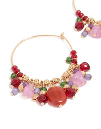 Designed with thin hoop closure adorned with colorful beaded charms in red, pink, green, and gold close up view - link has visual effect only