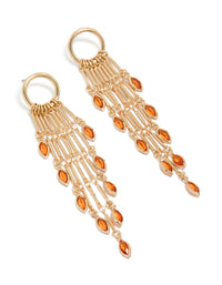 Showcasing statement style gold ring with long amber diamante chain drop earrings featuring tassel, charm in orange front view - link has visual effect only