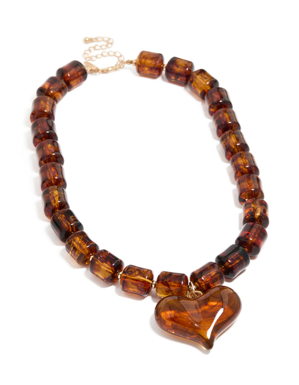 Crafted with brown square bead and heart necklace featuring statement in gold tones front view