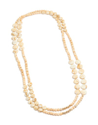 Showcasing cream acrylic beaded layered necklace with balls, round stone disc in beige ivory gold front view - link has visual effect only