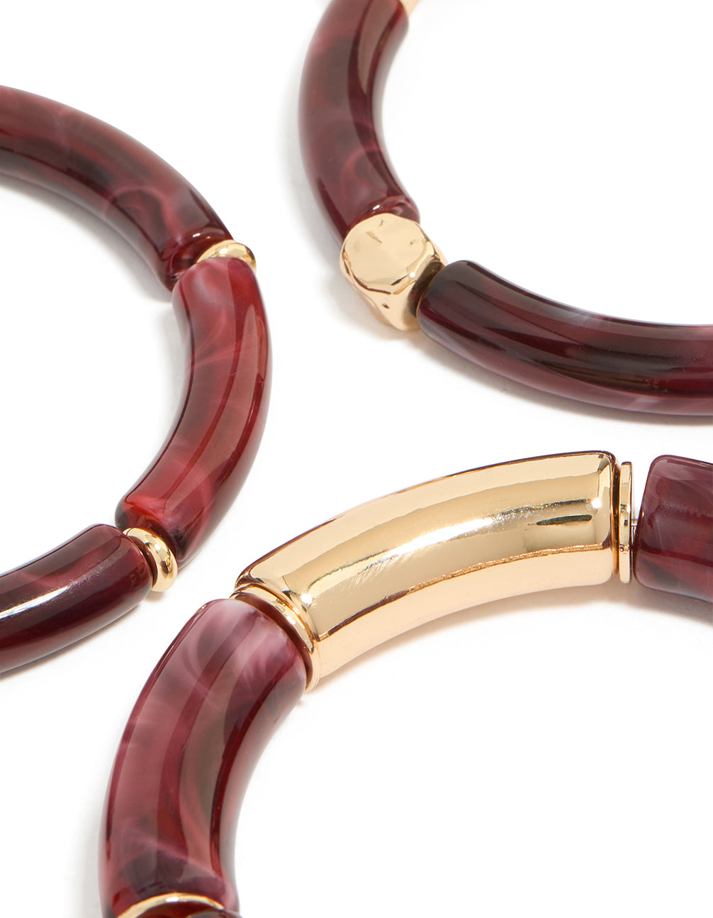 Highlighting mixed burgundy resin and gold stretch bracelets with beads in a 3-pack close up view
