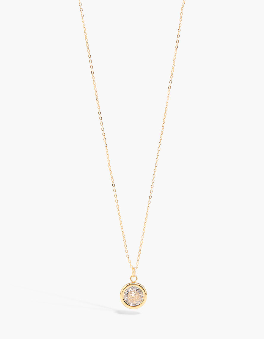Showcasing a waterproof slider bezel necklace crafted from gold plated stainless steel featuring cubic zirconia in a close up view
