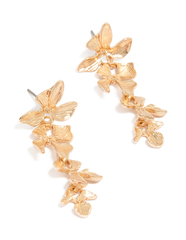 Showcasing statement drop earrings with textured flower petals in gold front view