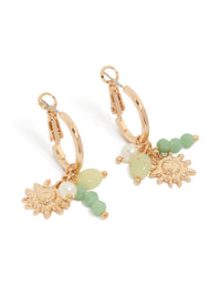 Showcasing dainty huggie earrings with sun charm, green beads, and pearls in gold front view - link has visual effect only