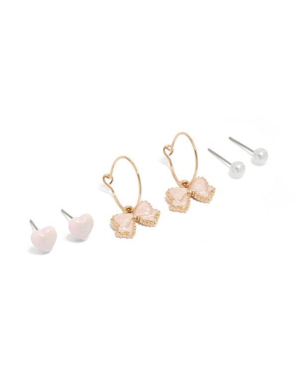 Showcasing gold pearl heart and bow earrings in a 3-pack with hoop and stud closures, pink and white accents front view