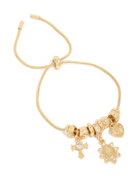 Showcasing a gold plated cubic zirconia heart and cross toggle bracelet with beads and charm details front view - link has visual effect only