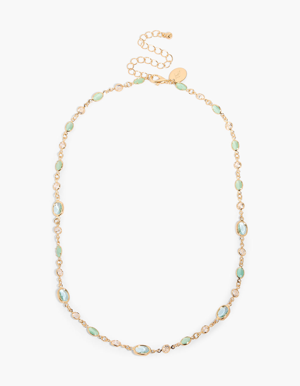 Displayed at an angle, this gold plated necklace with green cubic zirconia and oval close up view