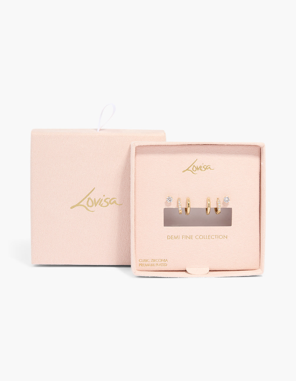 Crafted from gold plated cubic zirconia, this stud and huggie earrings 3-pack is presented in packaging close up view